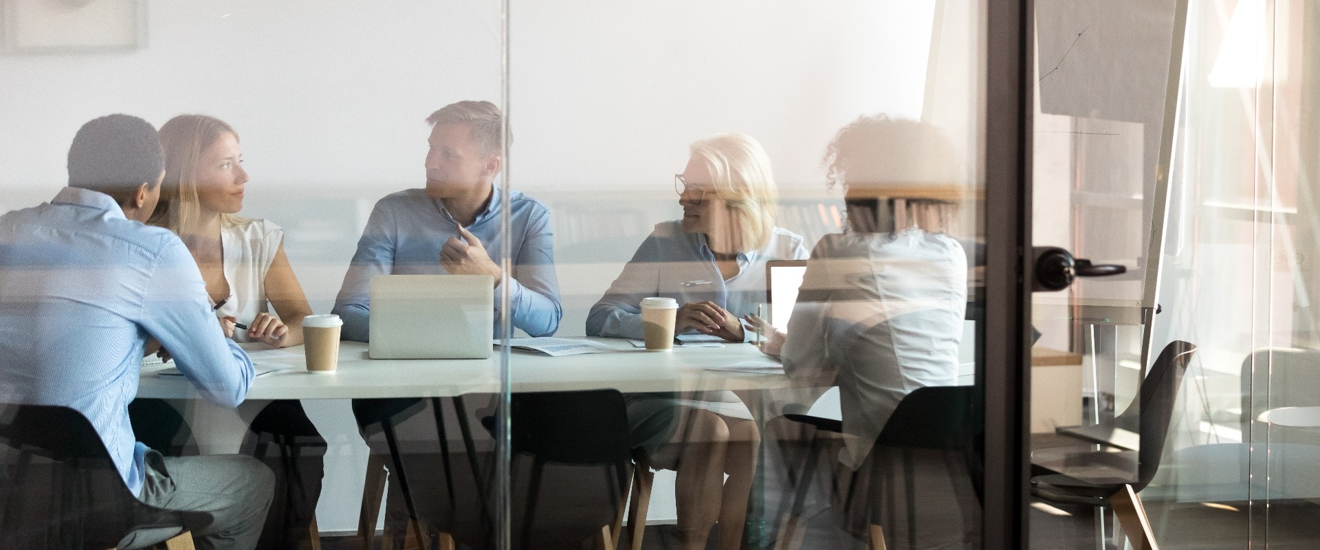 Business people negotiating at boardroom behind closed doors