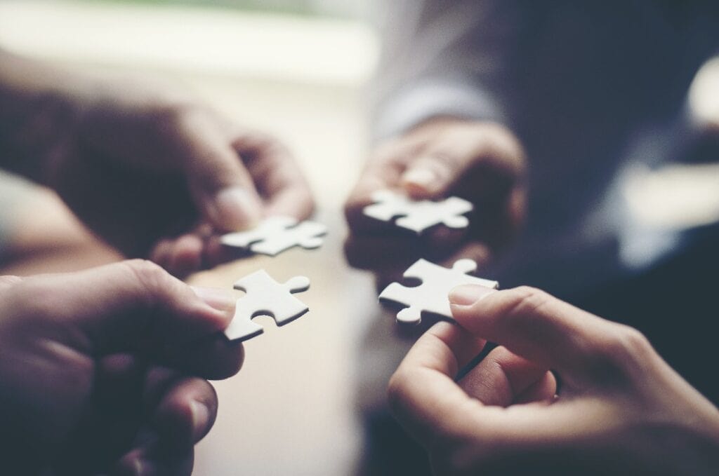 Hand holding jigsaw puzzles, Business partnership concept.